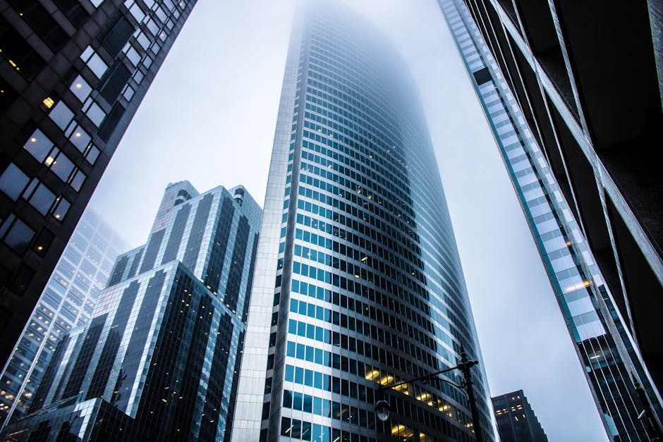 Dramatic view of modern skyscrapers shrouded in fog in an urban cityscape